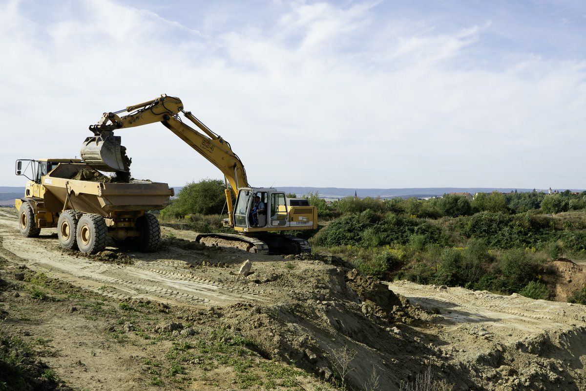 Bagger belädt einen Muldenkipper mit Ton in der Grube Brommelsberg